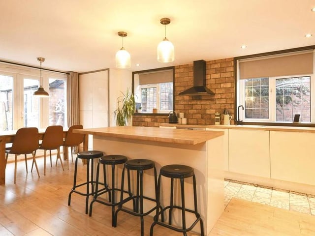 This photo captures the contemporary kitchen, with the dining area to the left. In the middle is an island, ideal for taking a family breakfast. The whole kitchen/diner has been completely refitted in recent times.