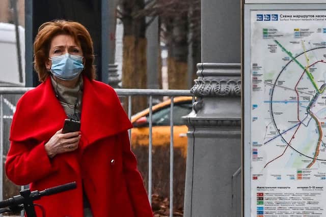 The Covid pandemic saw people in countries all over the world, like this woman in Moscow, start wearing face masks, observe social distancing and make other major changes to their way of life to safeguard themselves and others (Picture: Yuri Kadobnov/AFP via Getty Images)