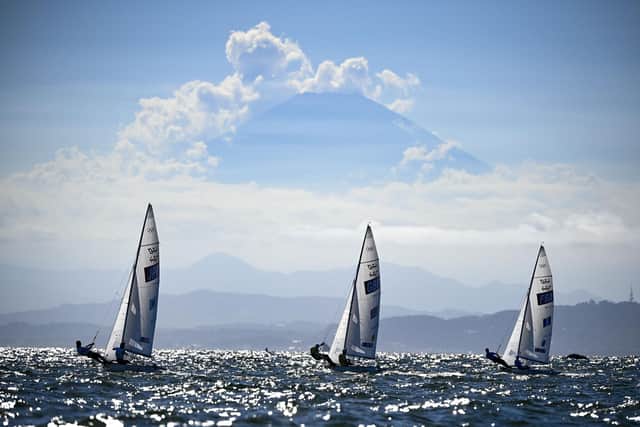 Japan's Ai Yoshida and Miho Yoshioka, Britain's Hannah Mills and Eilidh Mcintyre and France's Aloise Retornaz and France's Camille Lecointre sail past Mount Fuji during the women's two-person dinghy 470 medal race. Picture: Olivier Morin/AFP via Getty Images