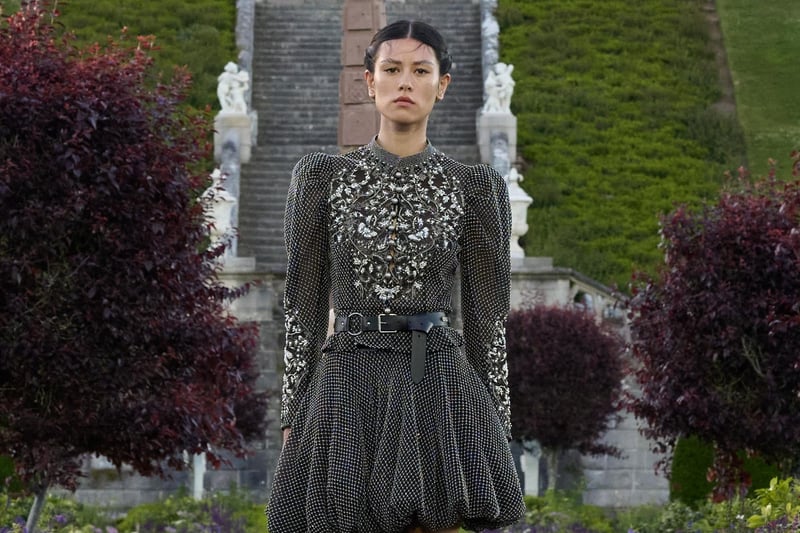 Puffed hem short dress, worn with knee-high leather boots.