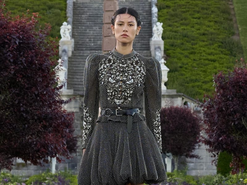 Puffed hem short dress, worn with knee-high leather boots.
