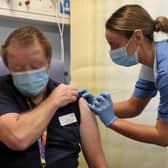 Deputy charge nurse Katie McIntosh giving Clinical Lead of Outpatient Theatres Andrew Mencnarowski, a Covid vaccine at the Western General Hospital in Edinburgh, on December 8.