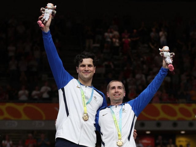 Gold medallists Neil Fachie and pilot Lewis Stewart celebrate on the podium during the medal presentation ceremony for the men's para-sport 1000m B time trial tandem.