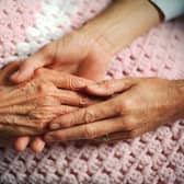 A geriatrician holds the hand of an elderly woman with arthritis. Picture: Corbis