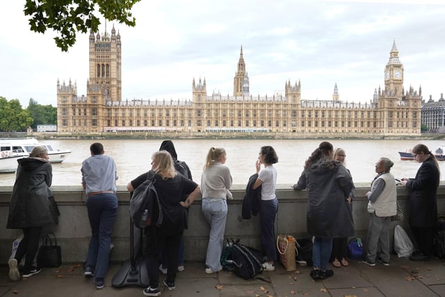 Members of the public join the queue on the South Bank, as they wait to view Queen Elizabeth II lying in state ahead of her funeral on Monday. Picture date: Wednesday September 14, 2022.