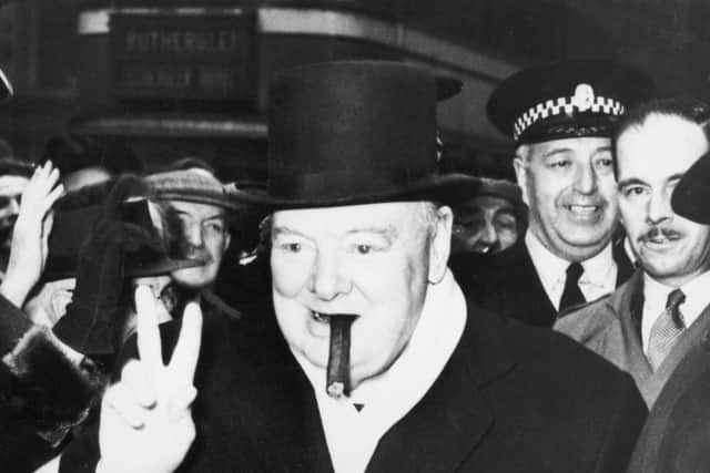 Winston Churchill gives his famous V-for-victory gesture on the campaign trail in Glasgow in 1951 (Picture: Keystone/Hulton Archive/Getty Images)