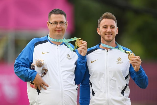 Gold medallists Garry Brown and Kevin Wallace of Team Scotland top the podium after winning the lawn bowls Para Men's Pairs B6-B8.