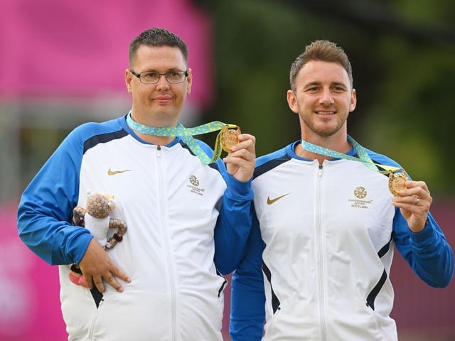 Gold medallists Garry Brown and Kevin Wallace of Team Scotland top the podium after winning the lawn bowls Para Men's Pairs B6-B8.