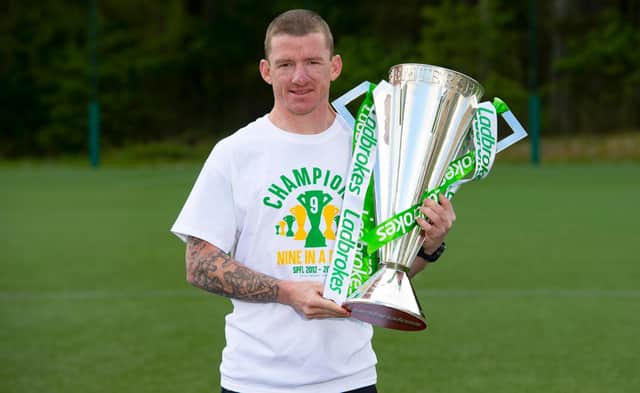 Departing Celtic winger Jonny Hayes is pictured with the Ladbrokes Premiership trophy.