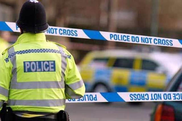 Generic police tape crime scene cordoned off emergency services. Police officer at scene