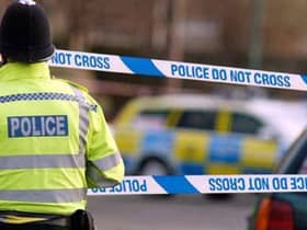 Generic police tape crime scene cordoned off emergency services. Police officer at scene