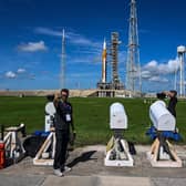 People set up remote cameras near the Artemis I rocket on the launch pad behind them at the Kennedy Space Center in Cape Canaveral, Florida. Picture: Chandan Khanna/AFP via Getty Images