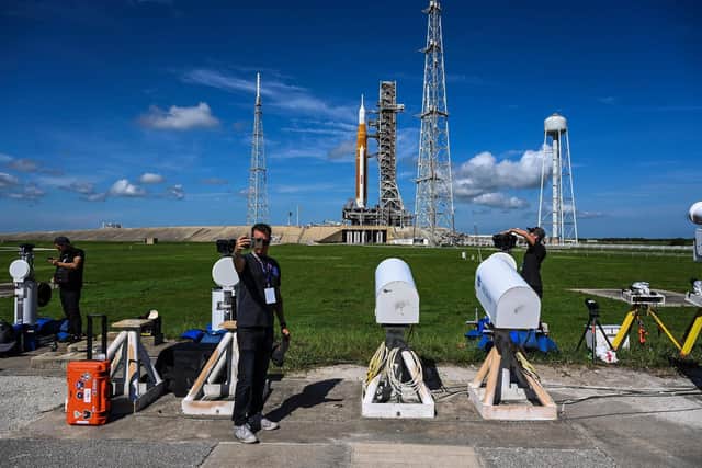 People set up remote cameras near the Artemis I rocket on the launch pad behind them at the Kennedy Space Center in Cape Canaveral, Florida. Picture: Chandan Khanna/AFP via Getty Images