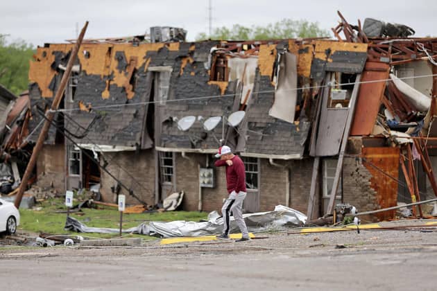 A man walks past tornado damage in Sulphur, Oklahoma, after severe storms hit the area. Picture: PA