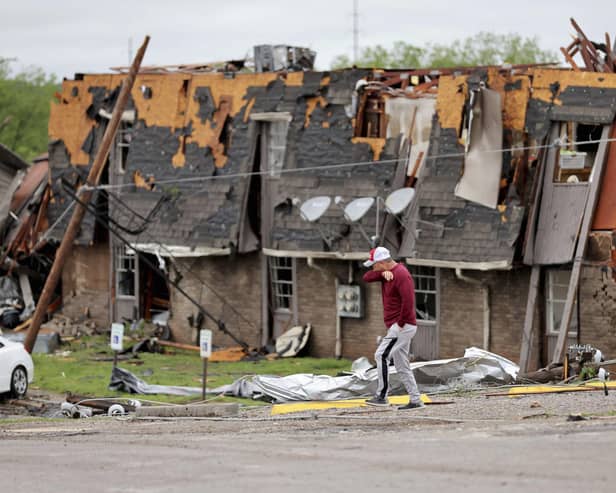 A man walks past tornado damage in Sulphur, Oklahoma, after severe storms hit the area. Picture: PA