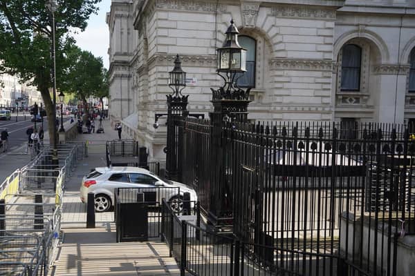 The scene after a car collided with the gates of Downing Street