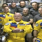 Russian cosmonauts Sergey Korsakov, Oleg Artemyev and Denis Matveyev emerged from the Soyuz capsule wearing yellow flight suits with blue stripes. Picture: Roscosmos via AP