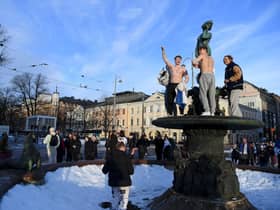 Ice hockey fans celebrate in Helsinki, after Finland's team won the Winter Olympic Games gold medal last year (Picture: Antti Aimo-Koivisto/Lehtikuva/AFP via Getty Images)