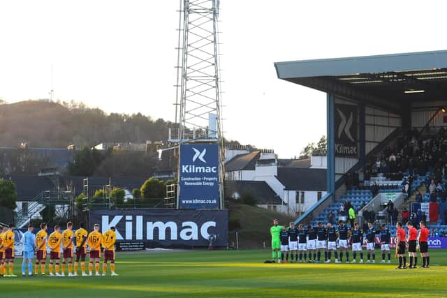 Dundee and Motherwell players observe a minute's silence in memory of Doug Cowie at Dens Park on Saturday. The home side went on to win 3-0. (Photo by Craig Foy / SNS Group)