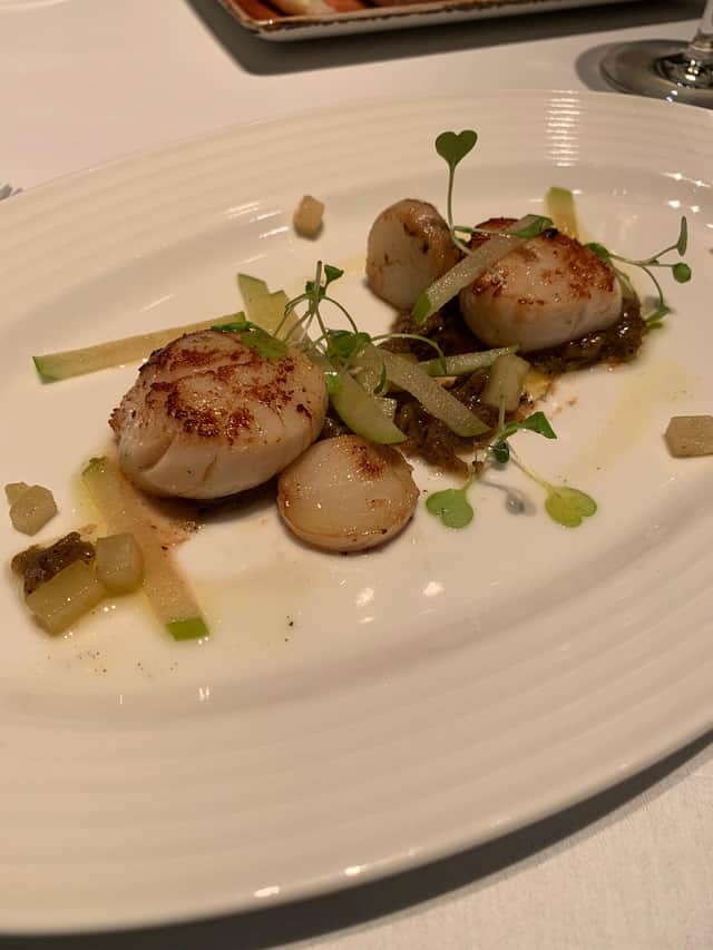 West Coast hand dived scallops with burnt apple puree, salt baked celeriac, vanilla, apple and cider vinaigrette.
