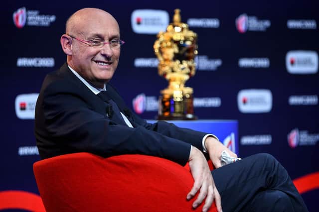 French Rugby Federation president Bernard Laporte beside the Rugby World Cup trophy at the pool stage draw in Paris.