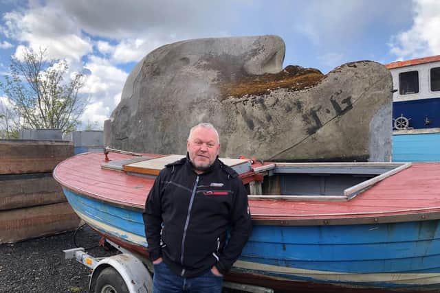 Andy Groom, brother of sculptor Richard, with the Floating Head sculpture in the boat yard in Clydebank. (Picture credit: Ross Crae)