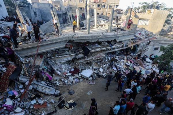 People search through buildings, destroyed during Israeli air raids in the southern Gaza Strip.