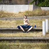 A man enjoys the sun in Holyrood Park in Edinburgh as the UK is hit by a heatwave. Picture: SWNS