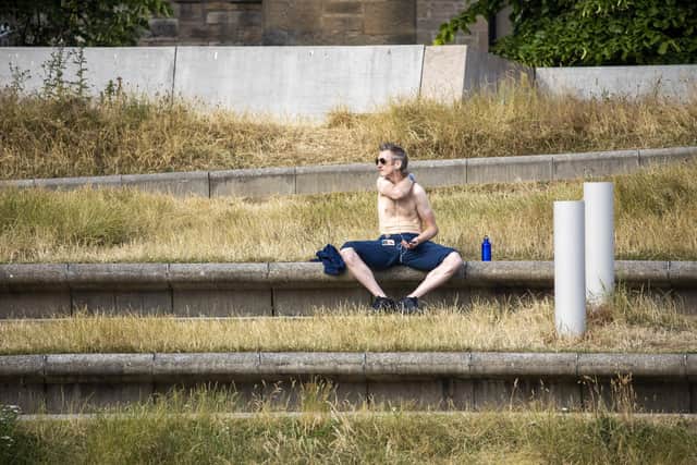 A man enjoys the sun in Holyrood Park in Edinburgh as the UK is hit by a heatwave. Picture: SWNS