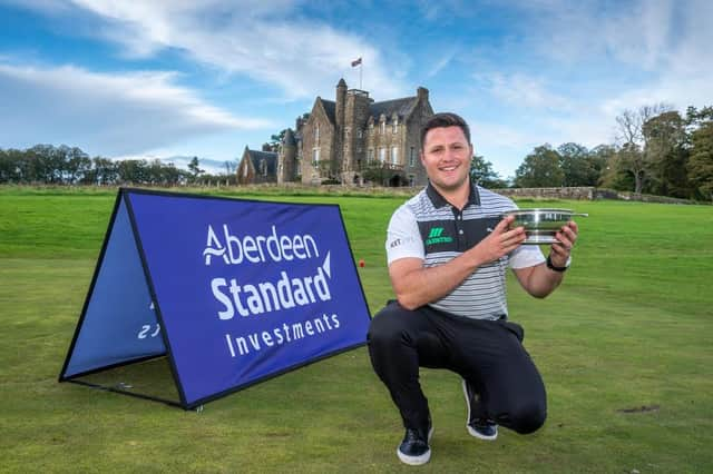 Dunbar's Neil Fenwick shows off the trophy for topping the Tartan Pro Tour Order of Merit to secure a spot in next week's Aberdeen Standard Investments Scottish Open at The Renaissance Club. Picture: Kenny Smith