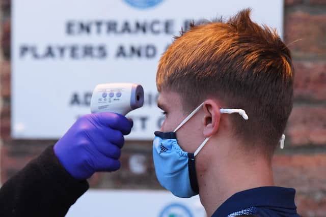 A Cove Rangers player is temperature tested pre match during a Betfred Cup match between Forfar and Hibernian at Station Park, on October 13, 2020, in Forfar, Scotland. Picture: Ross Parker / SNS Group