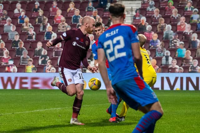 Hearts striker Liam Boyce flicks the second goal against Inverness into the net with his heel.