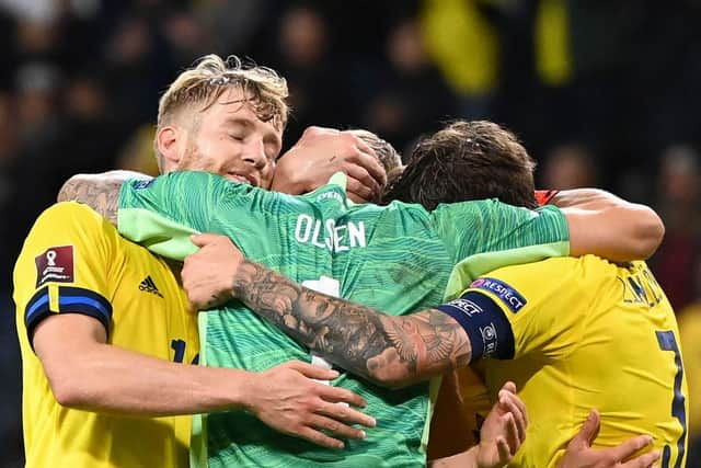 Sweden's goalkeeper Robin Olsen, Sweden's defender Filip Helander and Sweden's defender Victor Lindelof (R) embrace after their 2-1 win in the FIFA World Cup Qatar 2022 qualification Group B football match between Sweden and Spain.  (Photo by JONATHAN NACKSTRAND/AFP via Getty Images)