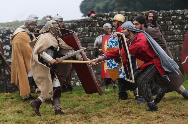 A re-enactment battle between Roman soldiers and ancient Britons at Hadrian's Wall is a reminder of the warlike past of the border (Picture: Owen Humphreys/PA)