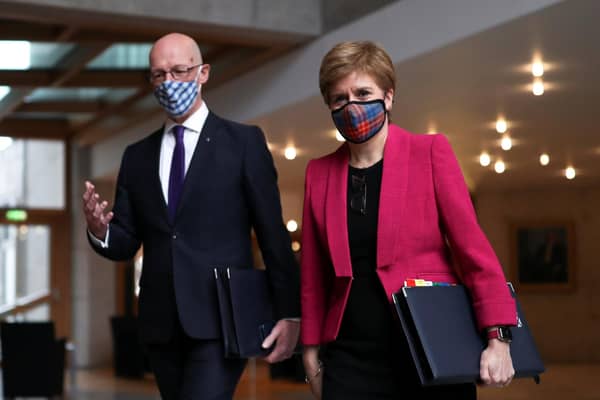 Nicola Sturgeon, and Deputy First Minister John Swinney arrive at parliament on Thursday