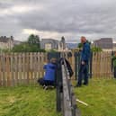 85th Greenock & District Scout Group volunteering with gardening work at HC-One Scotland’s Merino Court Care Home