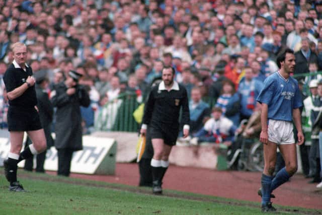 Rangers striker Mark Hateley leaves the field having been shown the red card by referee Andrew Waddell.