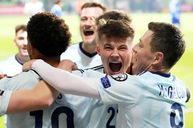 The scorer of the first, Nathan Patterson, celebrates after Che Adams put Scotland 2-0 up. (AP Photo/Sergei Grits)