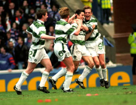 Celtic's John Collins (second right) celebrates his April 1994 derby goal in front of the Rangers fans with Simon Donnelly (right). The celebrations were accompanied by complete silence from the Rangers-only crowd after David Murray banned Celtic fans from the ground