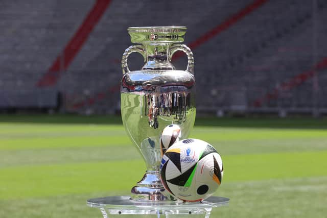 The European Championship trophy and official matchball on display at Munich's Allianz Arena, which will host Germany v Scotland in the tournament opener on Friday. (Photo by ALEXANDRA BEIER/AFP via Getty Images)