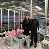 Joyce Gibson and Bryce Gibson of Direct Soccer in Dundee in front of the new machinery.