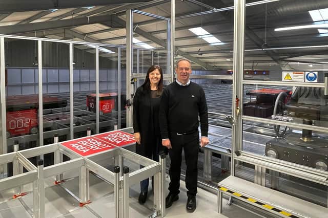 Joyce Gibson and Bryce Gibson of Direct Soccer in Dundee in front of the new machinery.