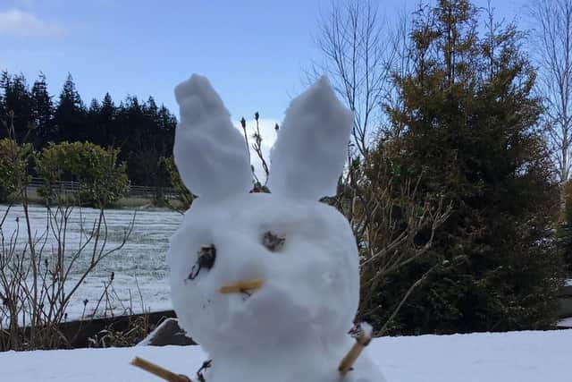 Kate Macleod, 37, helped her children build a snow bunny this morning (April 5) at 8am in Inverness, Scottish Highlands picture: SWNS
