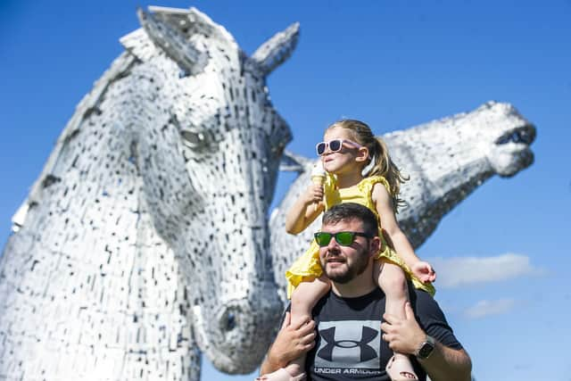 Jessica Ferguson enjoys an ice-cream with her father Mark Ferguson at the Kelpies in Falkirk. Picture: Lisa Ferguson