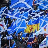 Protesters with Scottish Saltire flags attend a march organised by the grassroots organisation All Under One Banner calling for Scottish independence in Glasgow
