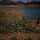 Personnel at Barragem do Arade reservoir, in the Algave, Portugal, where searches took place this week as part of the investigation into the disappearance of Madeleine McCann. Picture: Yui Mok/PA Wire