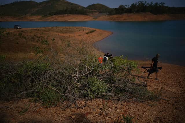 Personnel at Barragem do Arade reservoir, in the Algave, Portugal, where searches took place this week as part of the investigation into the disappearance of Madeleine McCann. Picture: Yui Mok/PA Wire