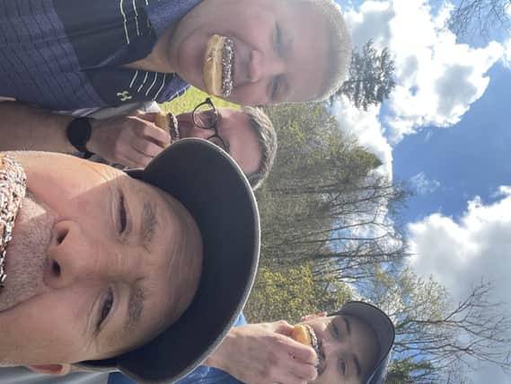 Fraser Jervis, left, tucks into a donut with some of his team-mates for the Dispatch Trophy.