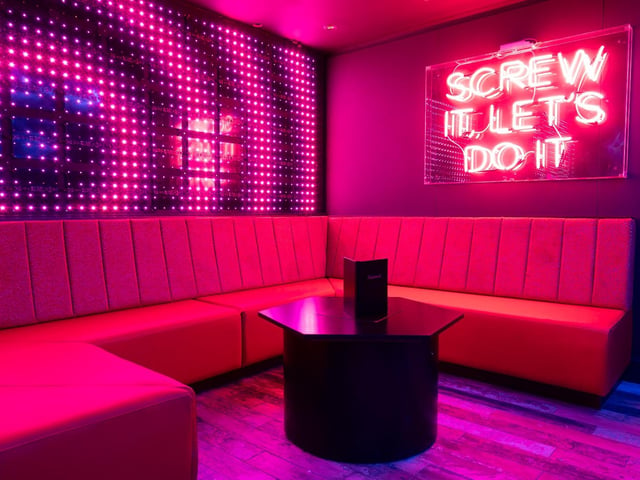 Neon signs are one of the quirky aspects to this late night bar.