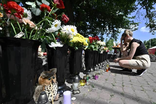 People lay flowers and children toys next to destroyed Amstor mall in Kremenchuk, after it was hit by a Russian missile (Picture: Genya Savilov/AFP via Getty Images)